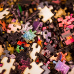 Close up of pile of wooden jigsaw puzzle pieces