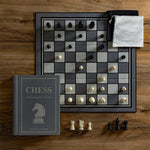 Chess Vintage Bookshelf Edition in play. Fabric-wrapped book with integrated storage. Full-sized folding game board, 32 Wooden Chess pieces, 2 Fabric pouches and instructions.