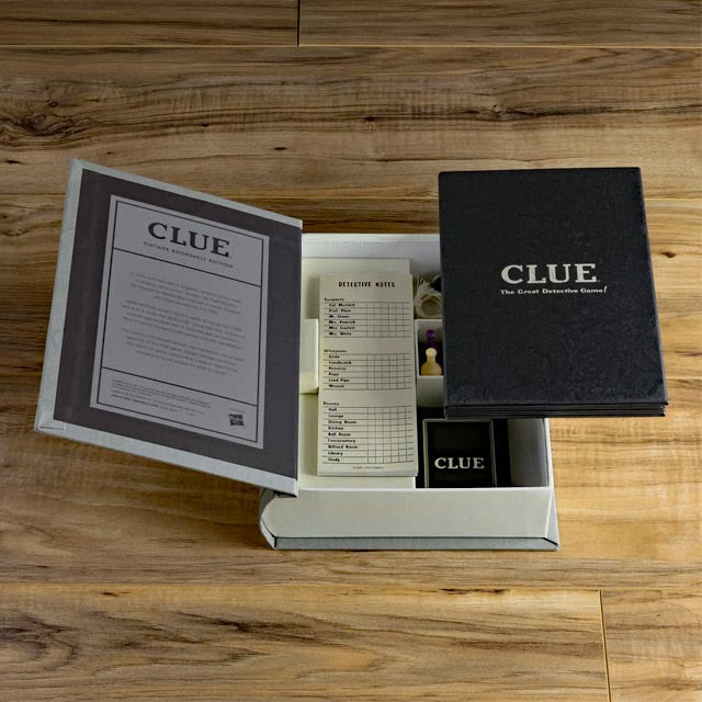 Clue Vintage Bookshelf Edition. Shown with tribute to the classic 1949 game board and cards, wood movers with die-cast bases, die-cast weapons, pad of detective notes and 6 pencils.